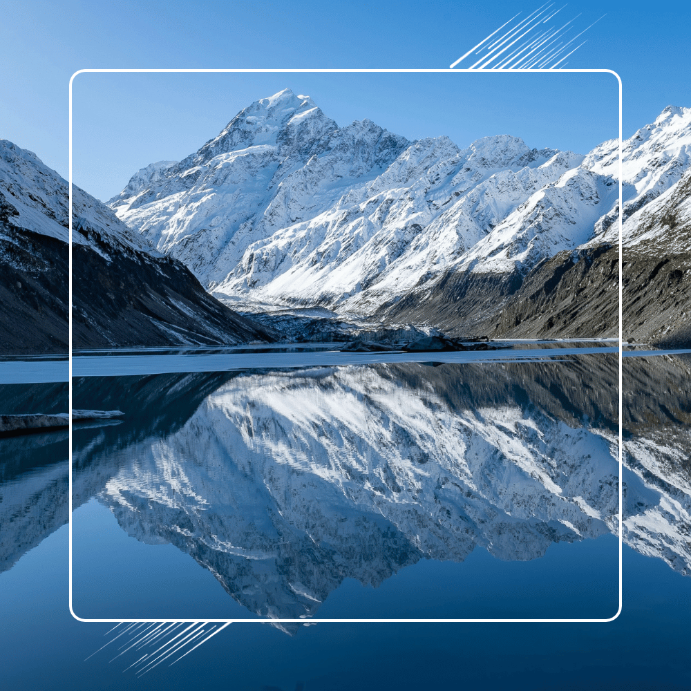 Snowcpped mountins reflected on lake with white boarder and line graphics in foreground