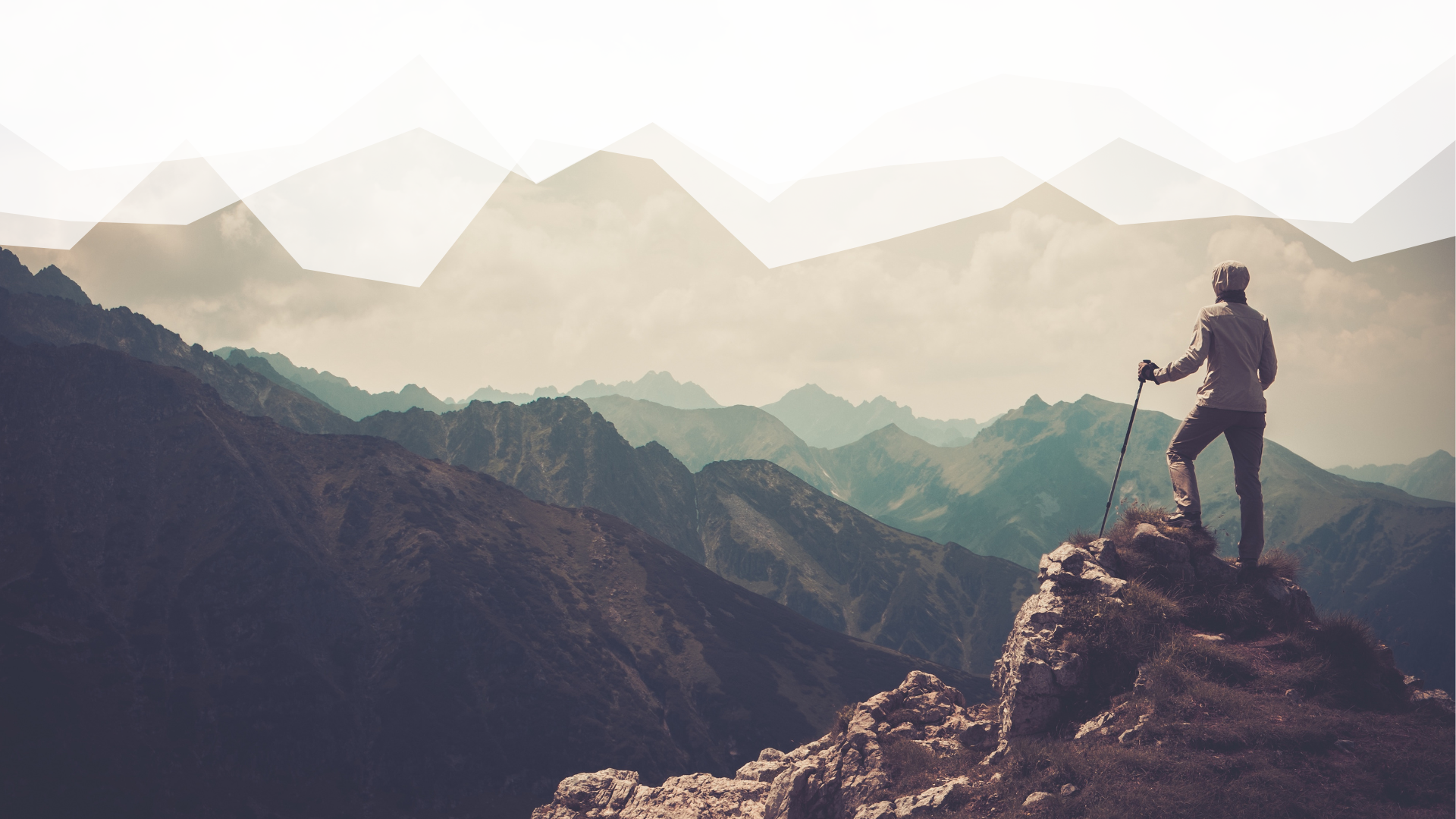 Hiker on mountain top looking out at vista