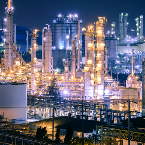 Exterior factory landscape at night with blue and yellow lights